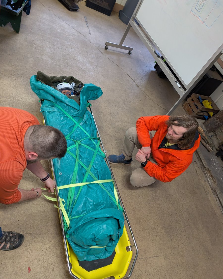 Packaging a patient in a litter during a technical rescue drill